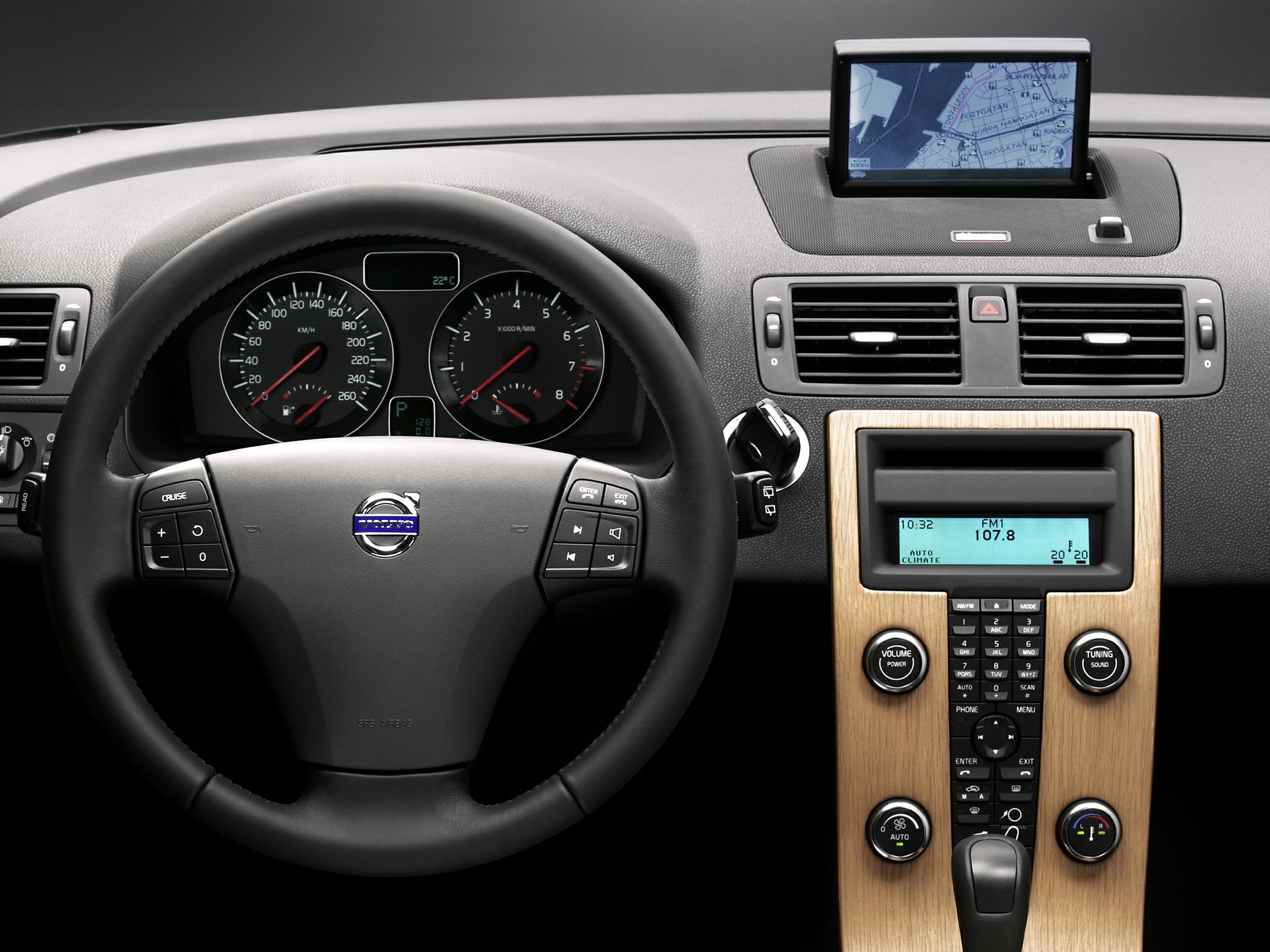 Steering wheel, instrument cluster, navigation display, wood center console.