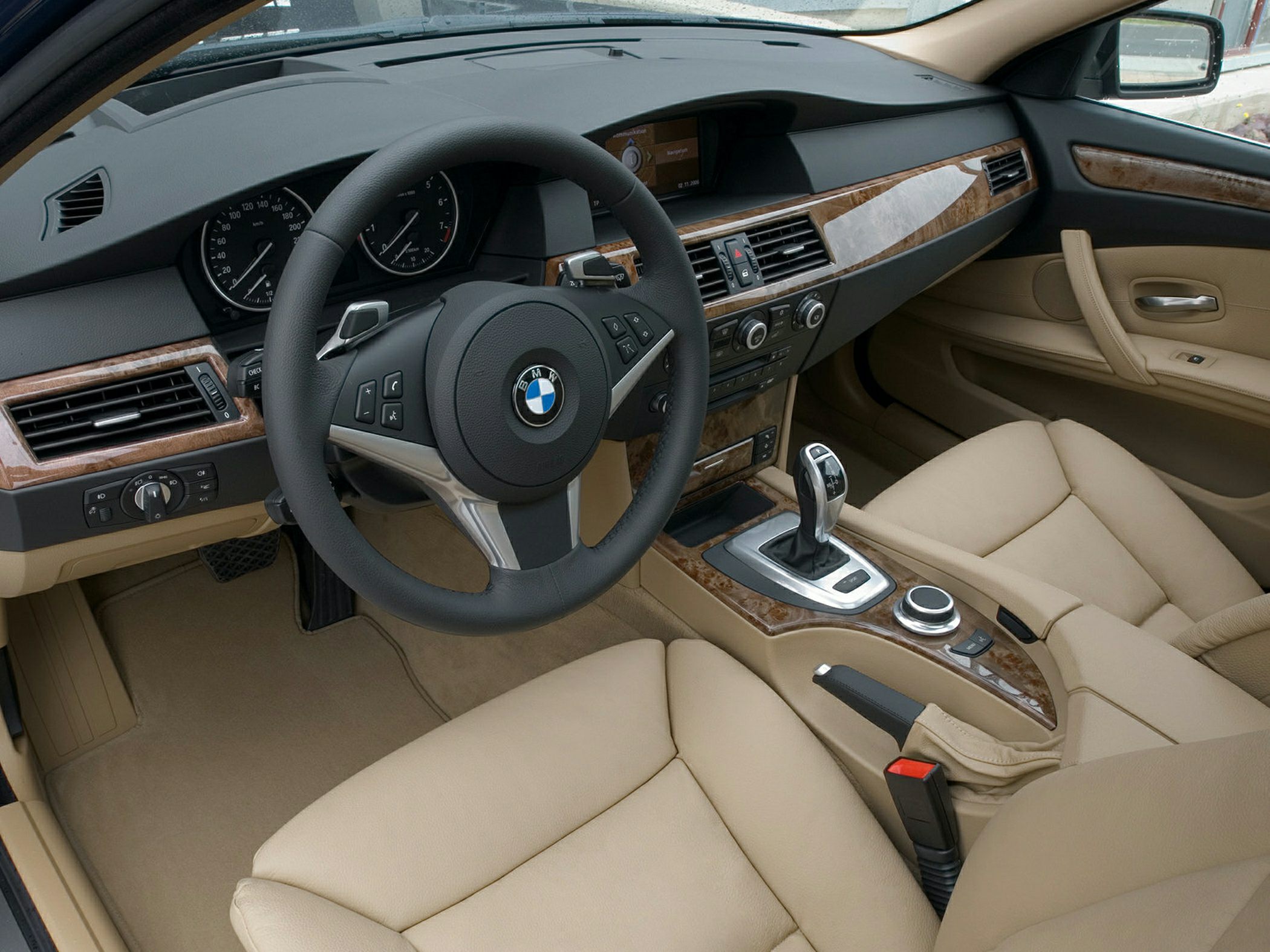 Beige leather interior with wood trim dashboard and automatic gear shifter
