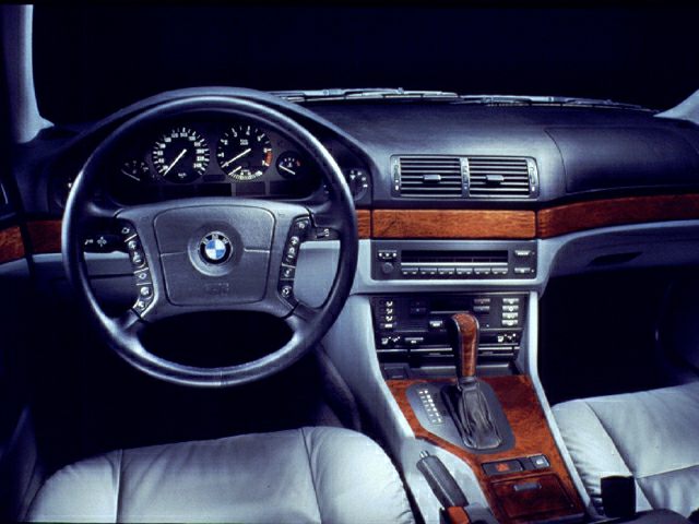 Interior dashboard with wood trim and multifunction steering wheel