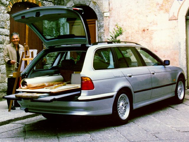 Open rear hatch with spacious cargo area on silver station wagon