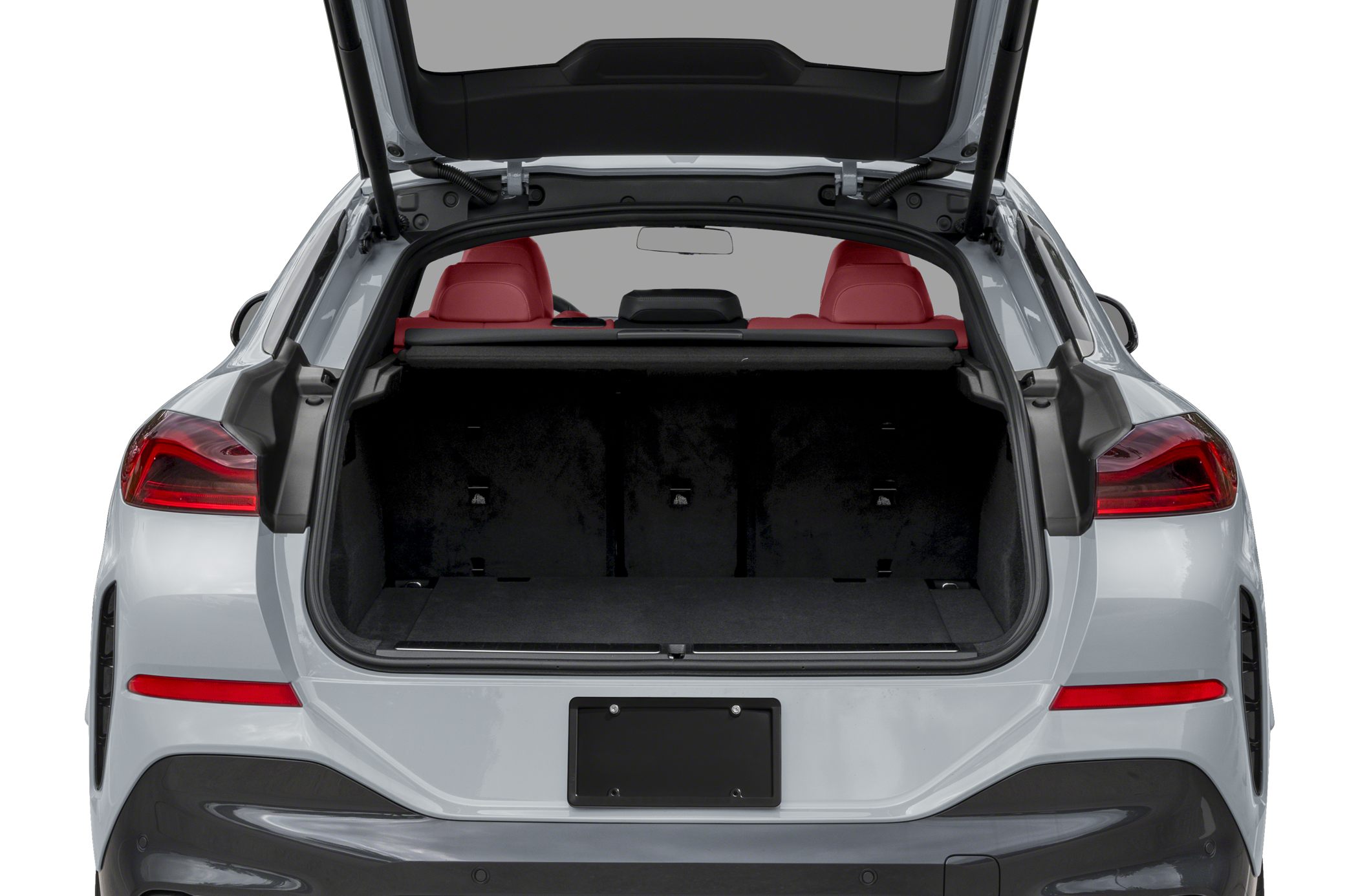 Rear view of open trunk with spacious cargo area and red rear seats
