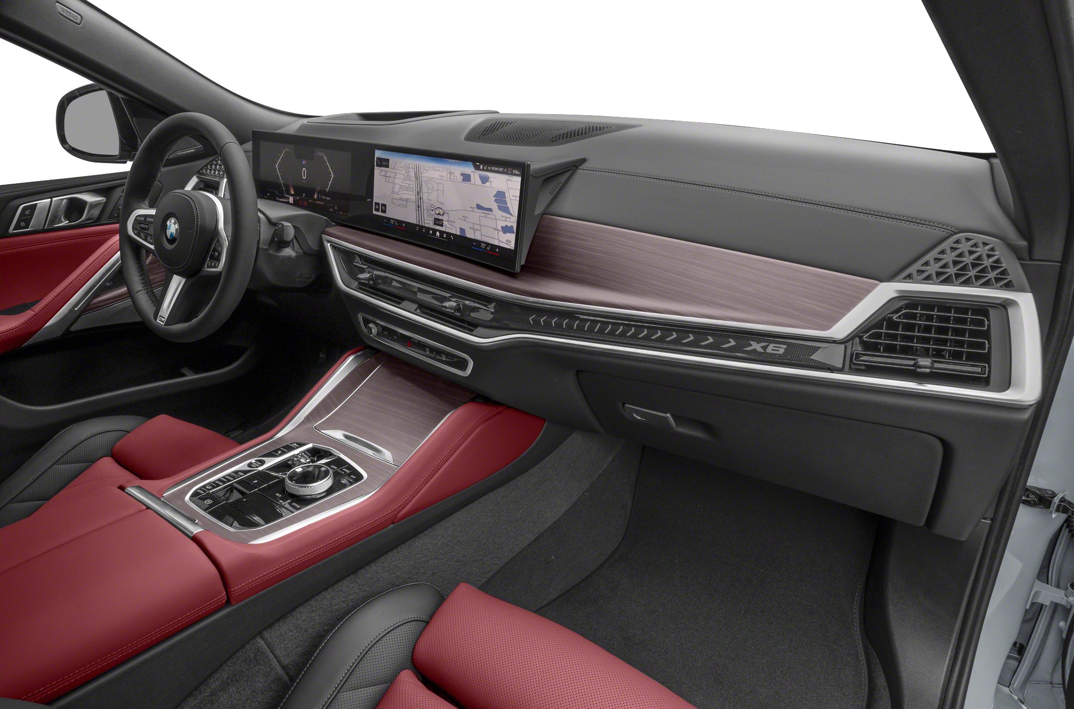 Dual digital displays, red leather seats, and wood trim in vehicle interior