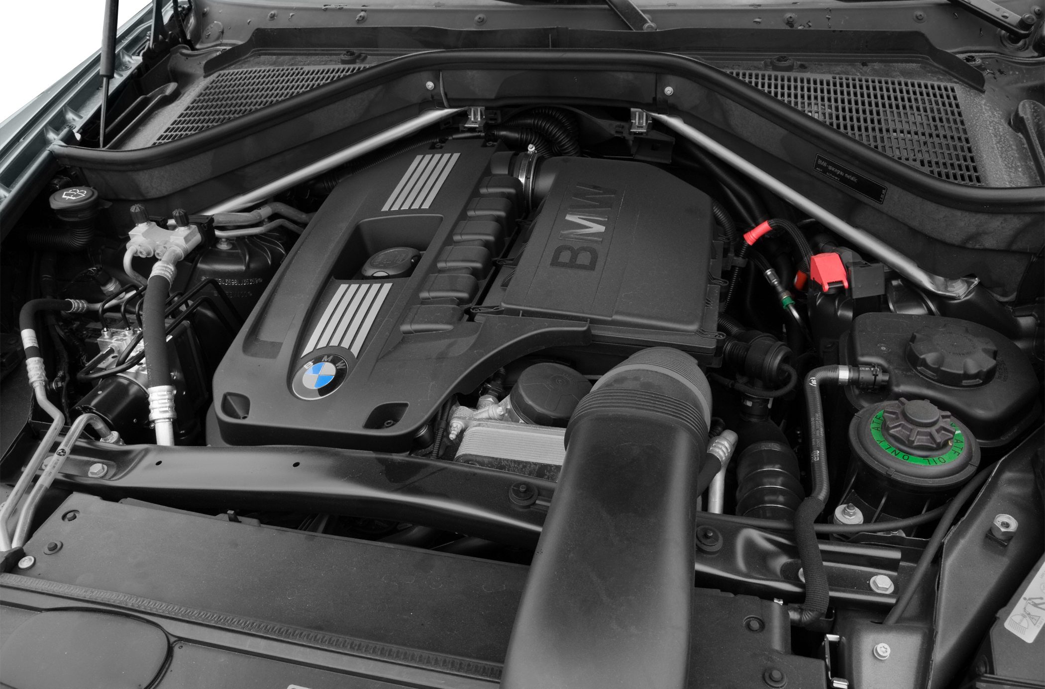 Engine bay with BMW branded motor cover and mechanical components
