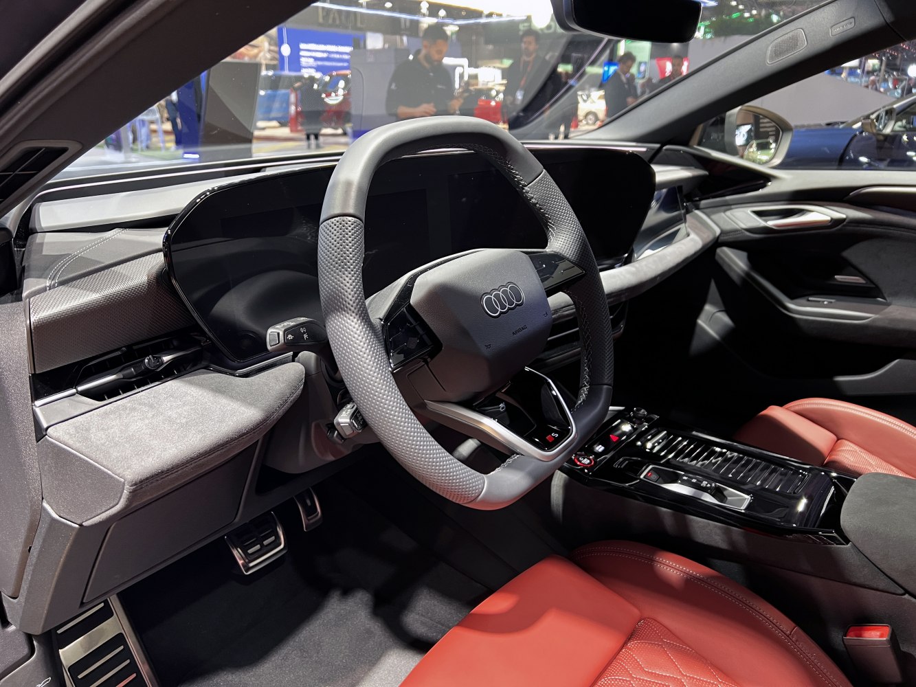 Sporty steering wheel with digital dashboard and red leather seats