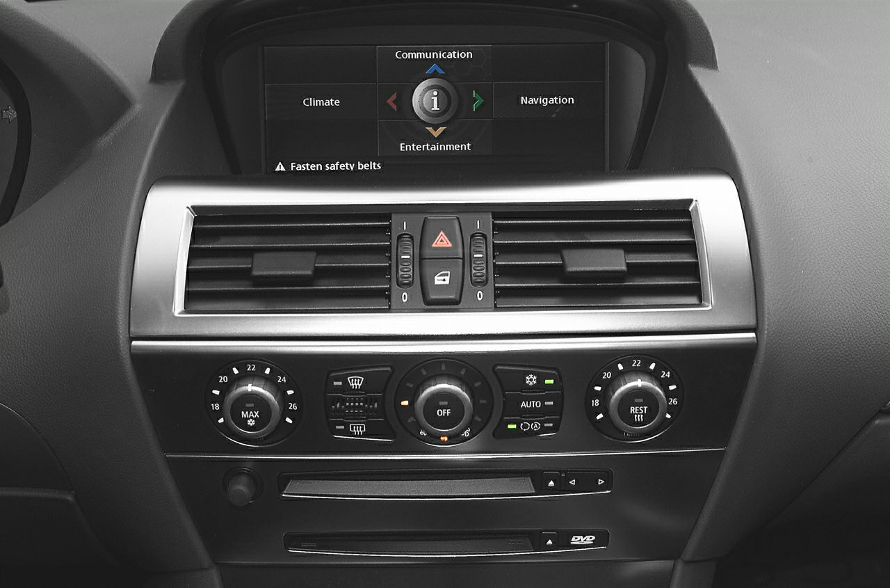 Dashboard climate controls with infotainment screen and air vents