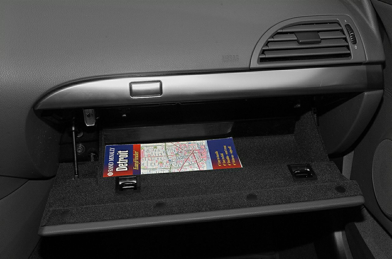 Open glove compartment with a map inside BMW interior