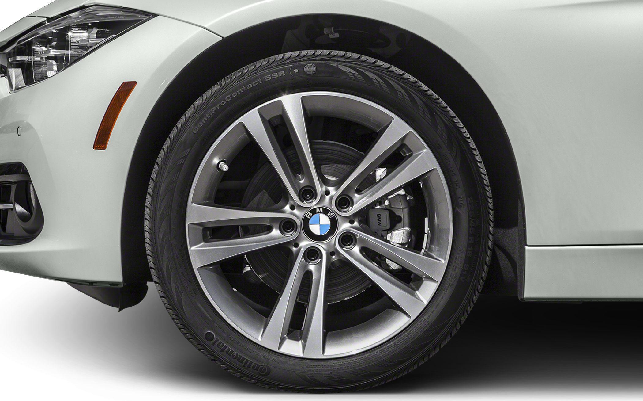 Alloy wheel and brake caliper on a silver vehicle front side.