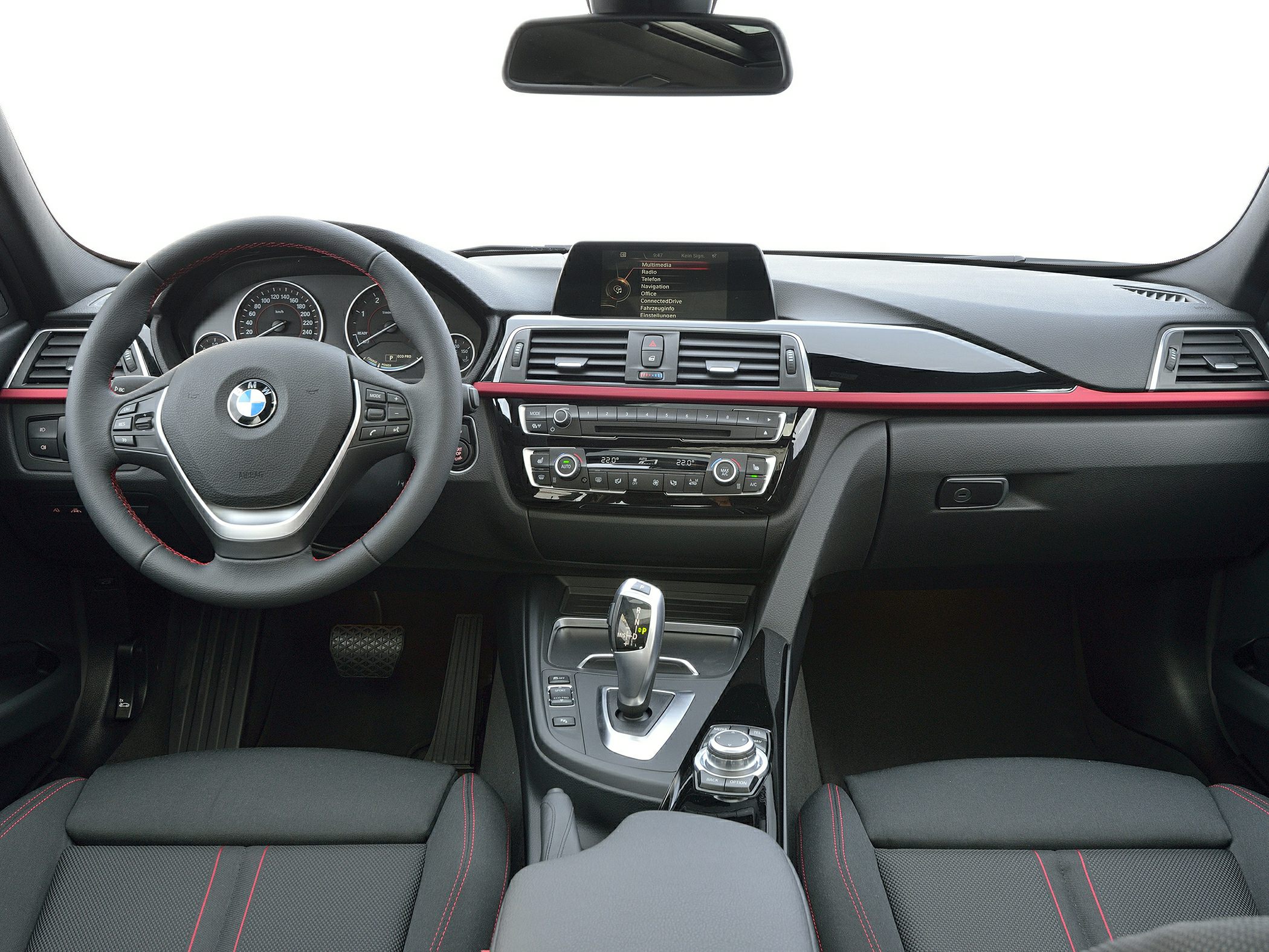 BMW interior with dashboard and steering wheel featuring multimedia display and gear shifter