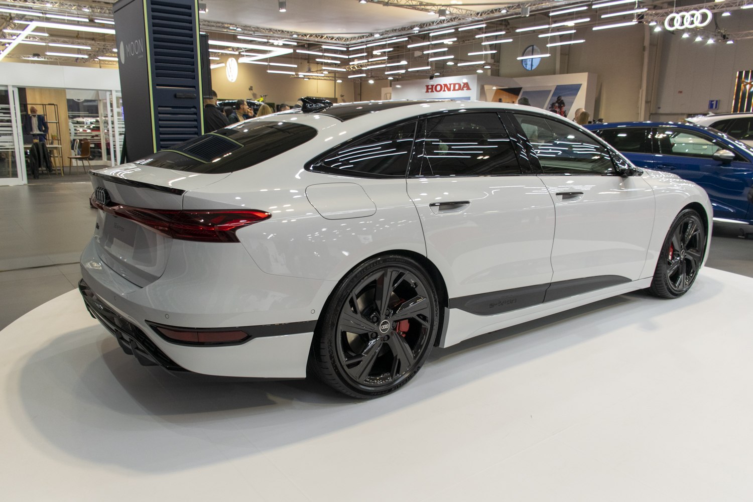 Rear side profile of sleek electric sportback with black alloy wheels