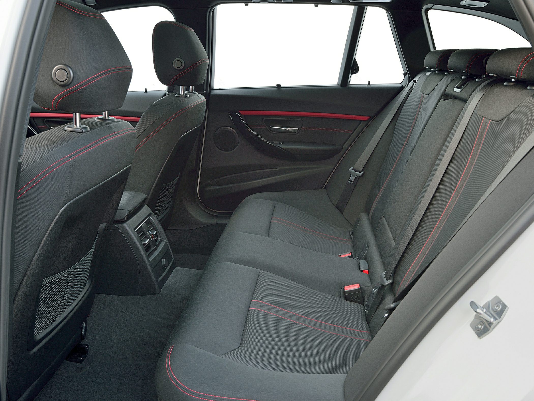 Rear seats with black fabric upholstery and red stitching plus ventilation panel.