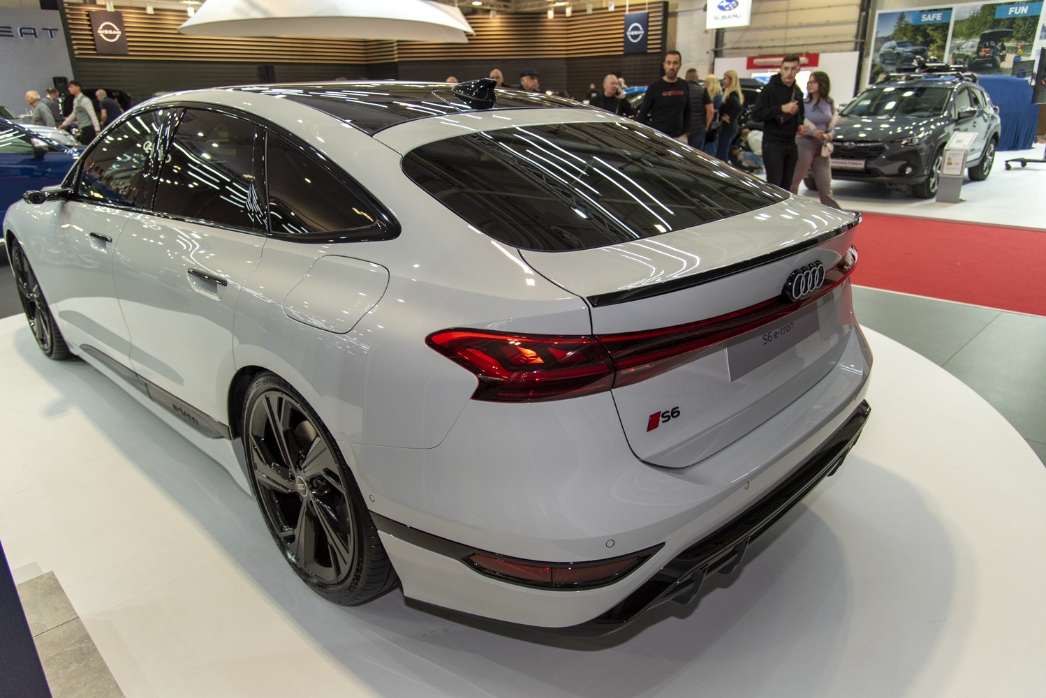 Rear view of a modern sleek electric hatchback with aerodynamic taillights.