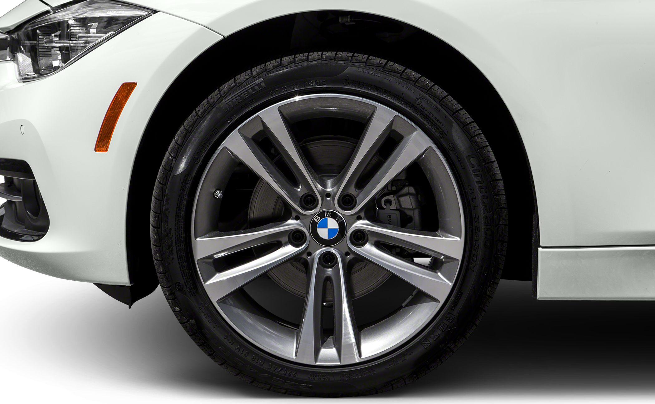 Close-up of alloy wheel and white front fender with indicator light