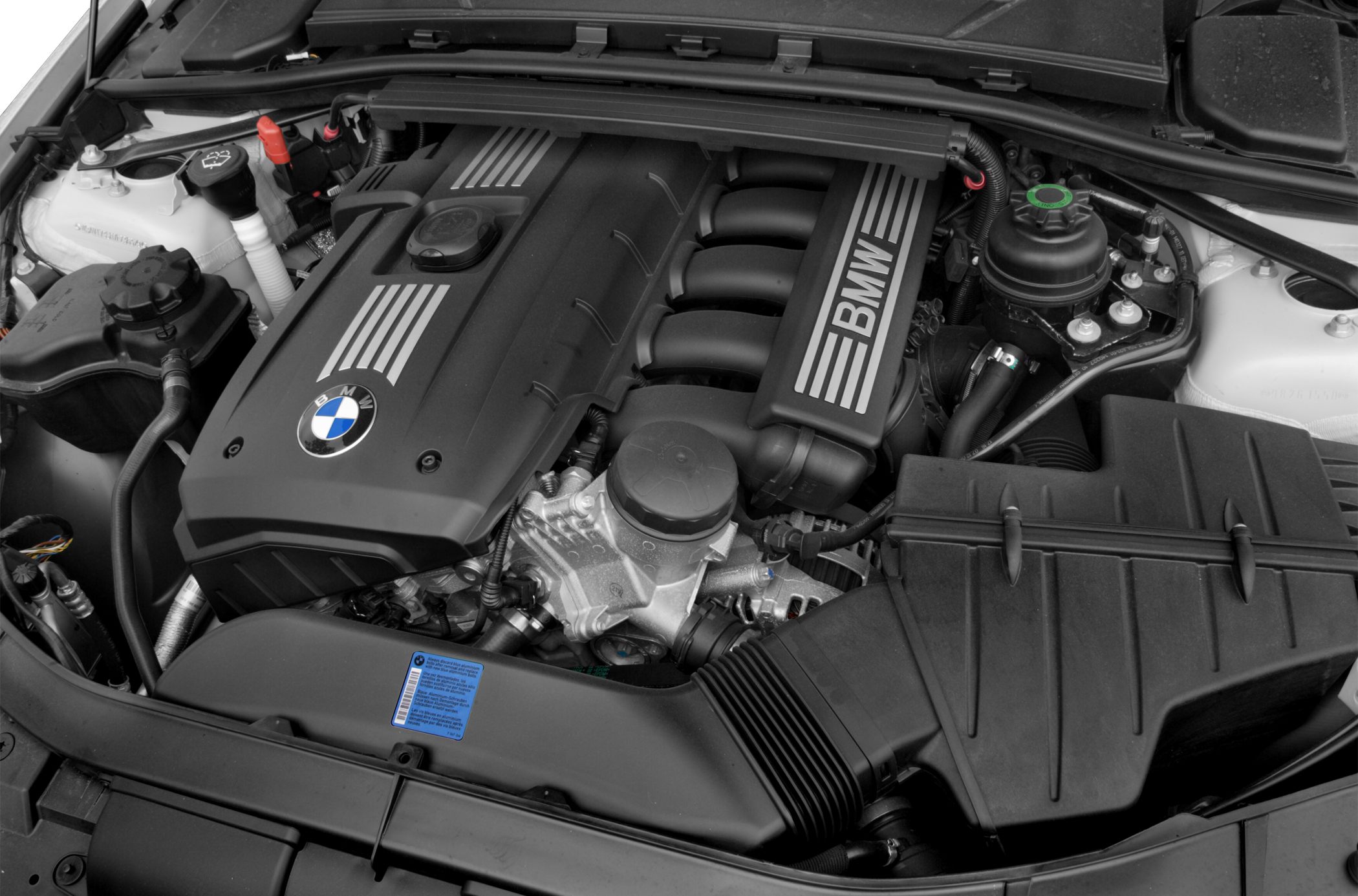 Close-up of BMW inline engine and engine bay components.