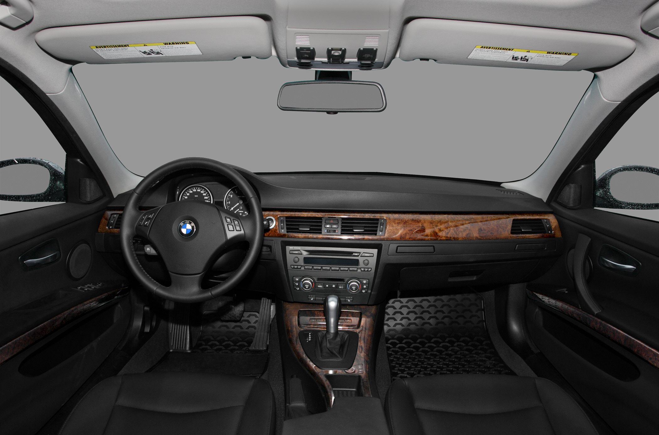 Steering wheel, dashboard with wood trim, and central console interior view