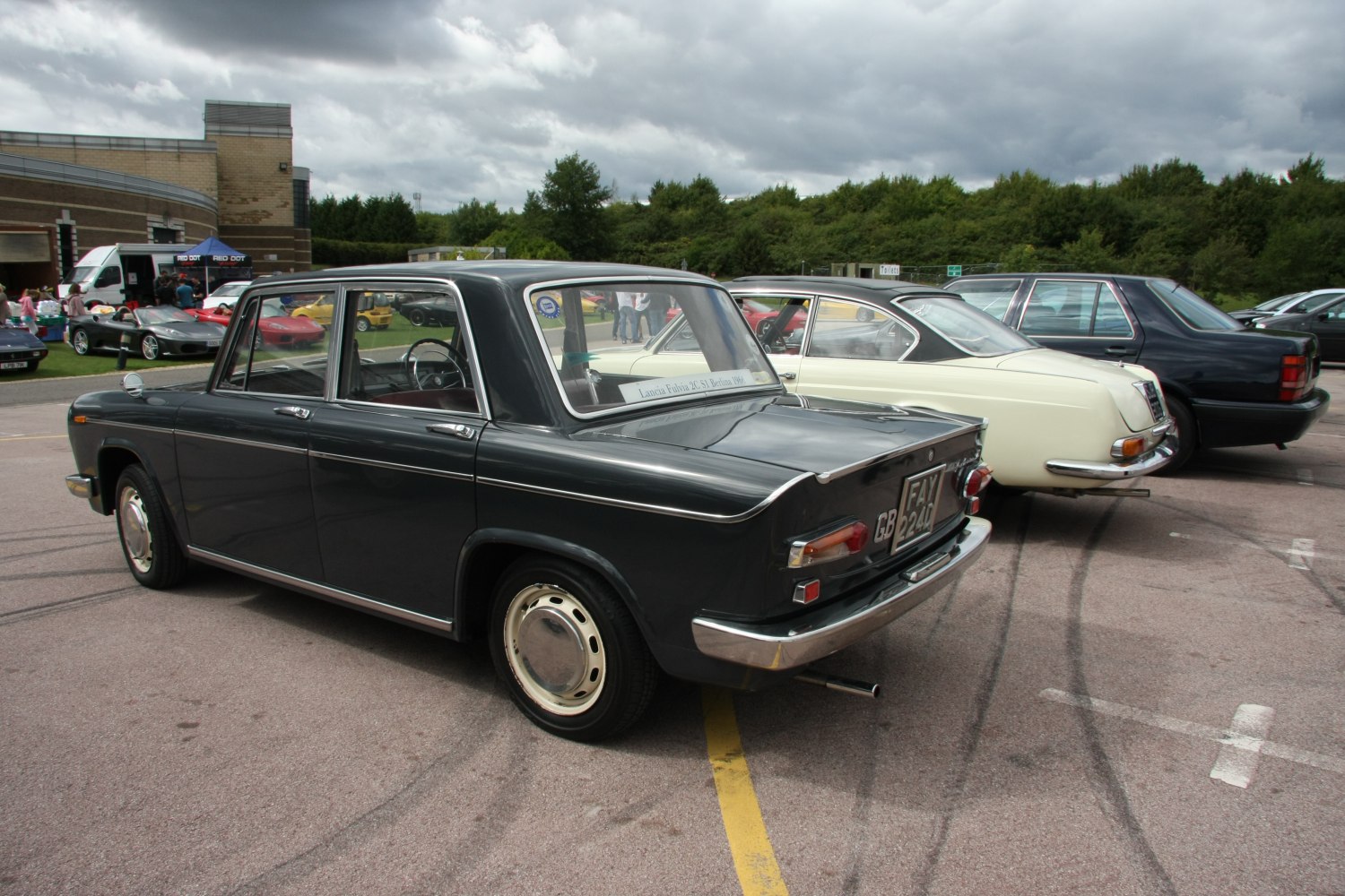 Rear and side view of a vintage sedan with chrome trim and tail fins