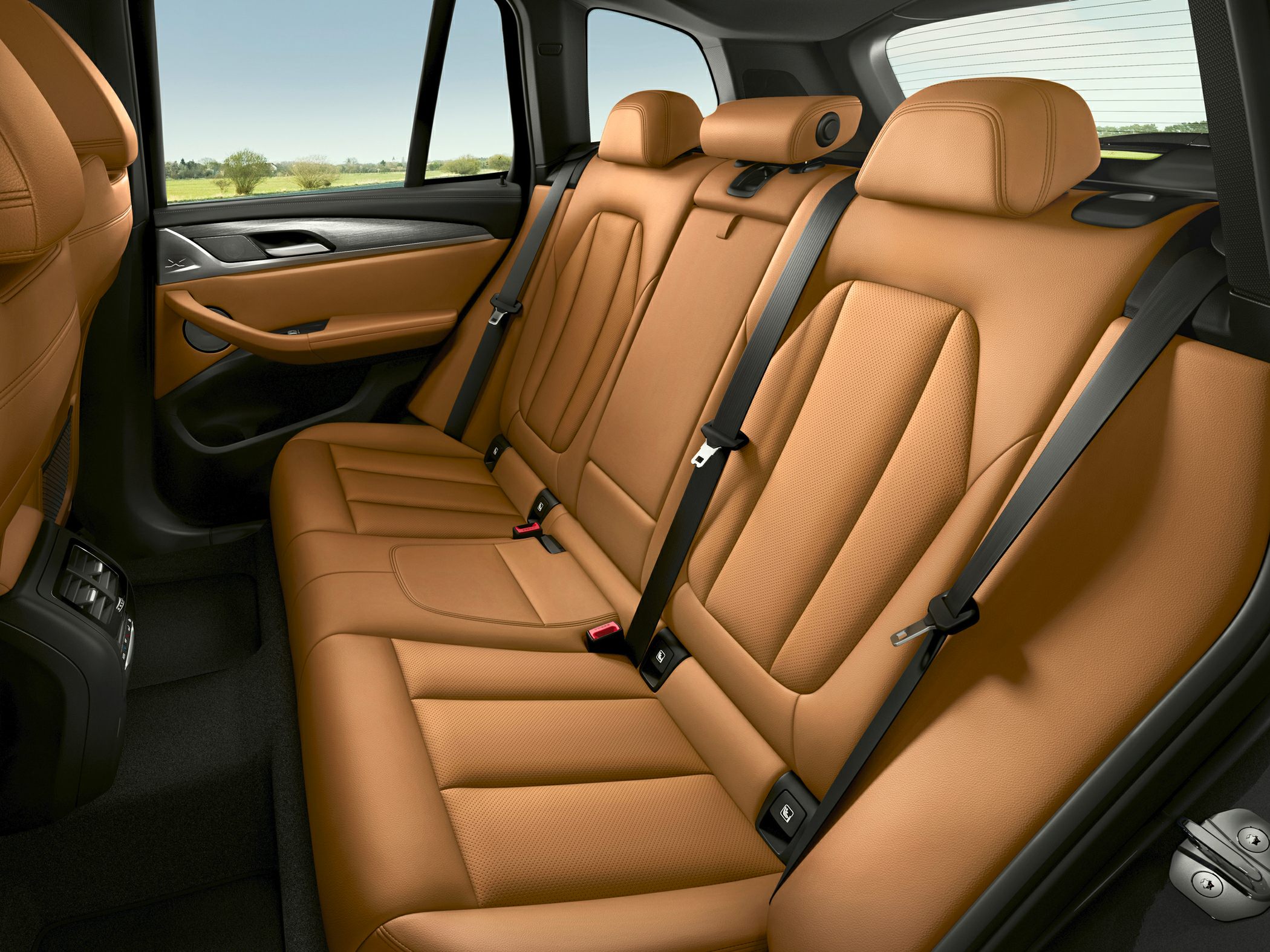Rear tan leather seats with seat belts and modern door panel