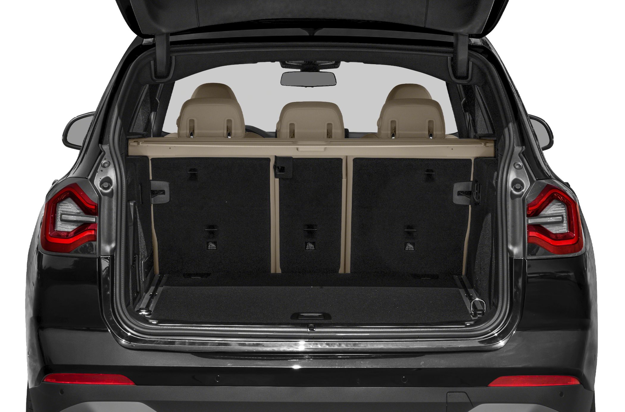Spacious rear cargo area with beige three-seat interior and open trunk.