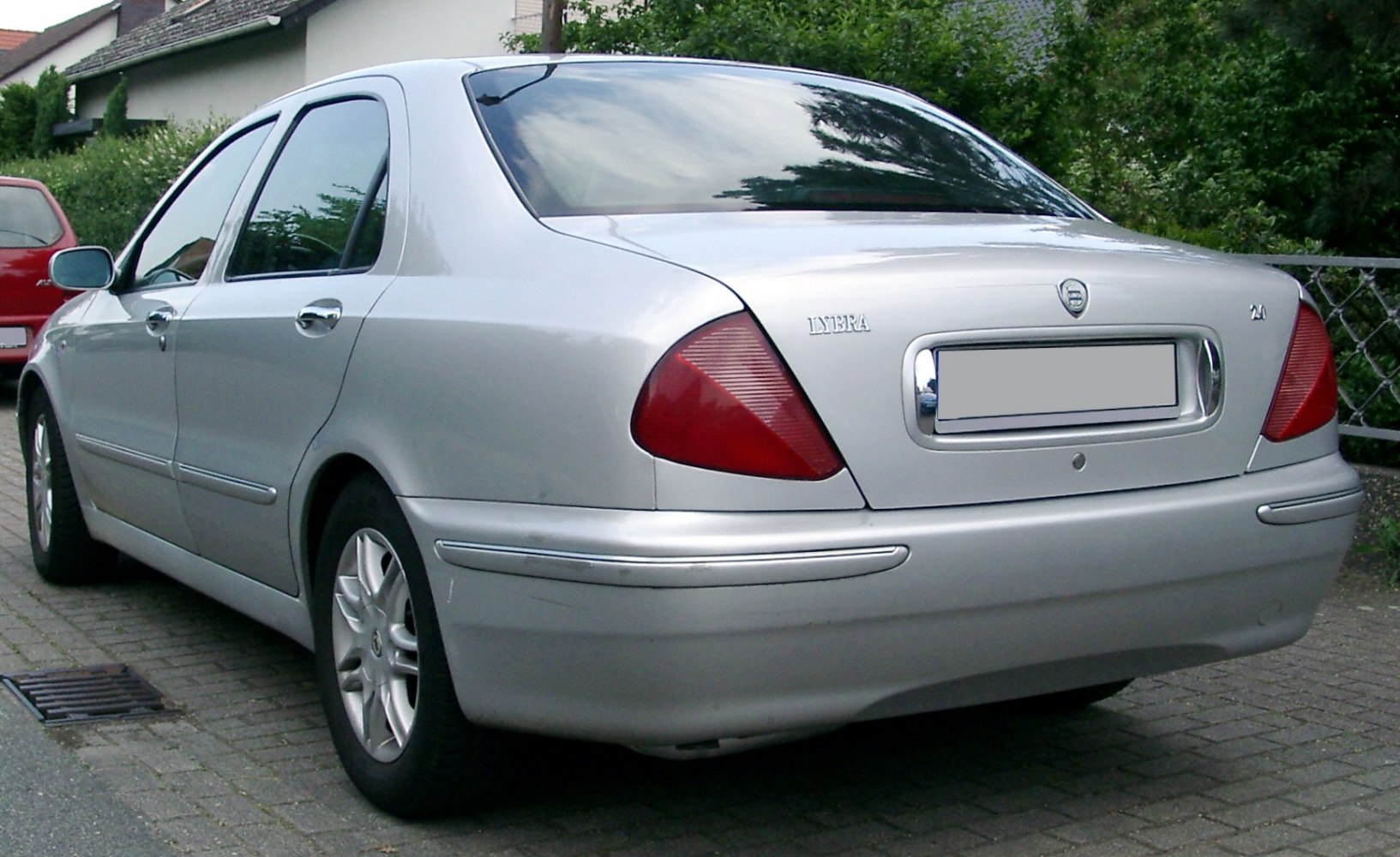 Silver sedan rear with distinctive triangular tail lights and smooth body design
