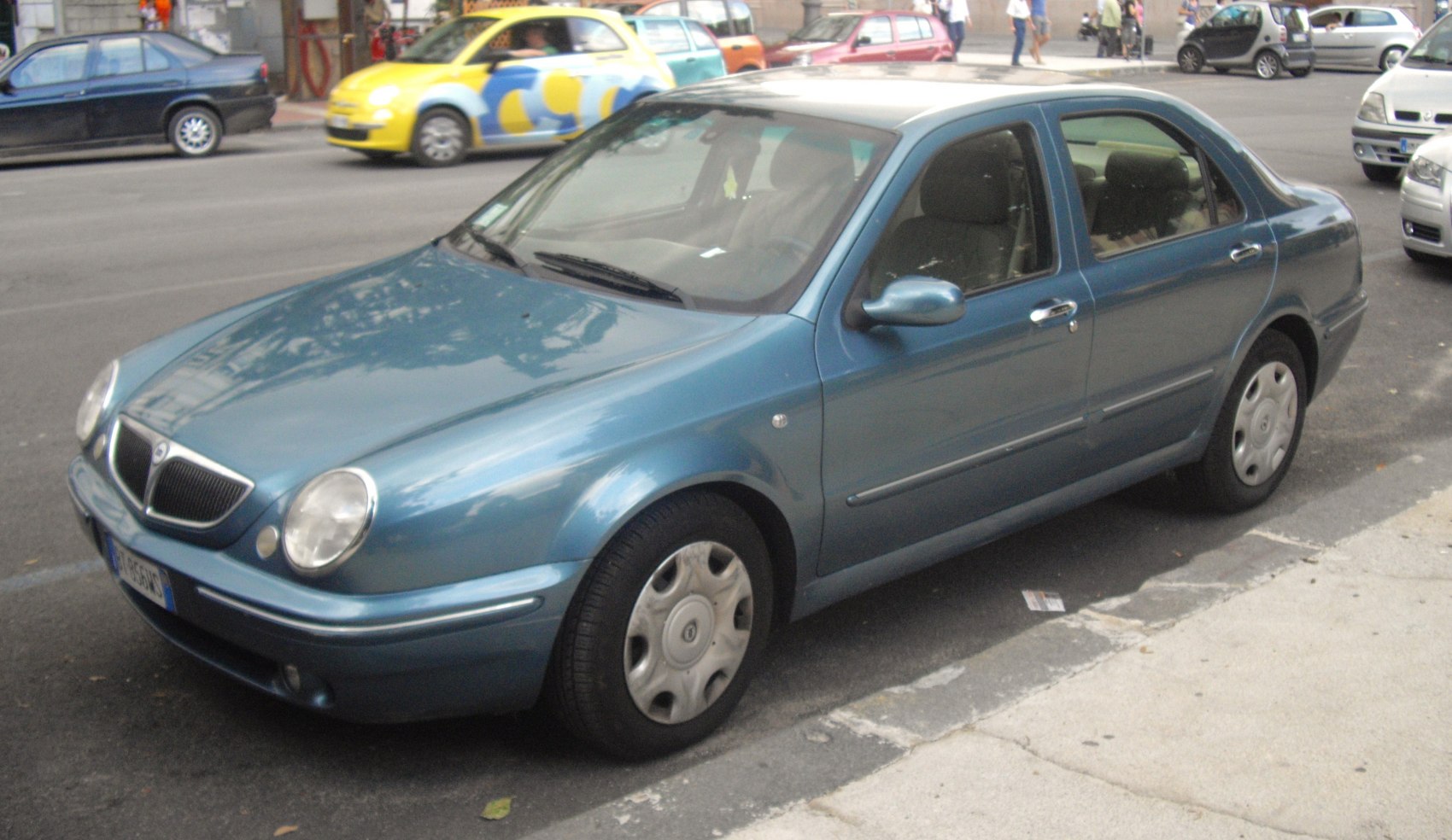 Front-side view of a classic 4-door sedan with round headlights and smooth body lines