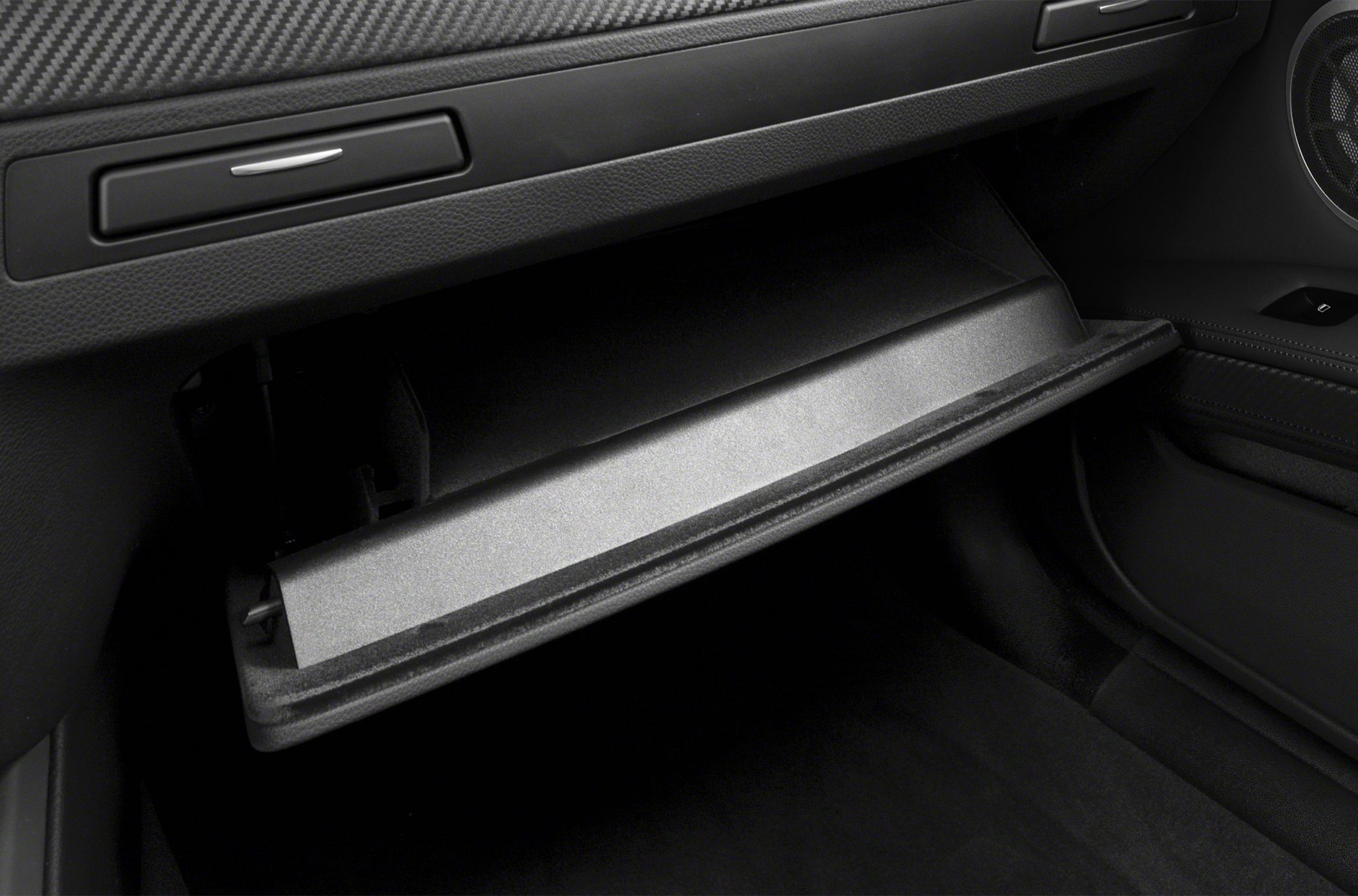 Open glovebox with carbon-fiber dashboard trim in luxury convertible interior