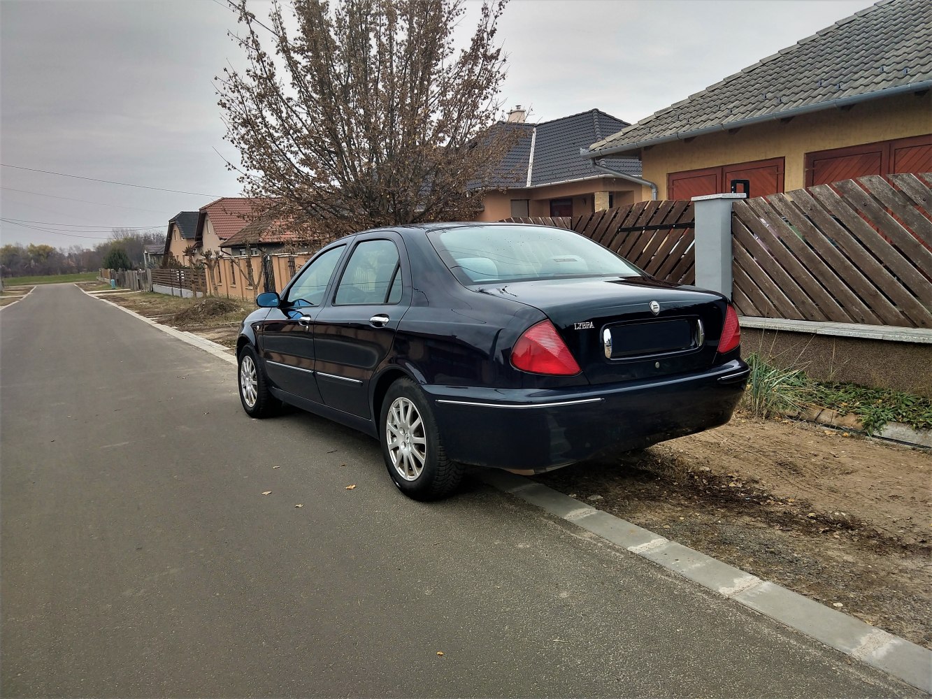 Rear view of a black mid-sized sedan with distinctive tail lights and alloy wheels.