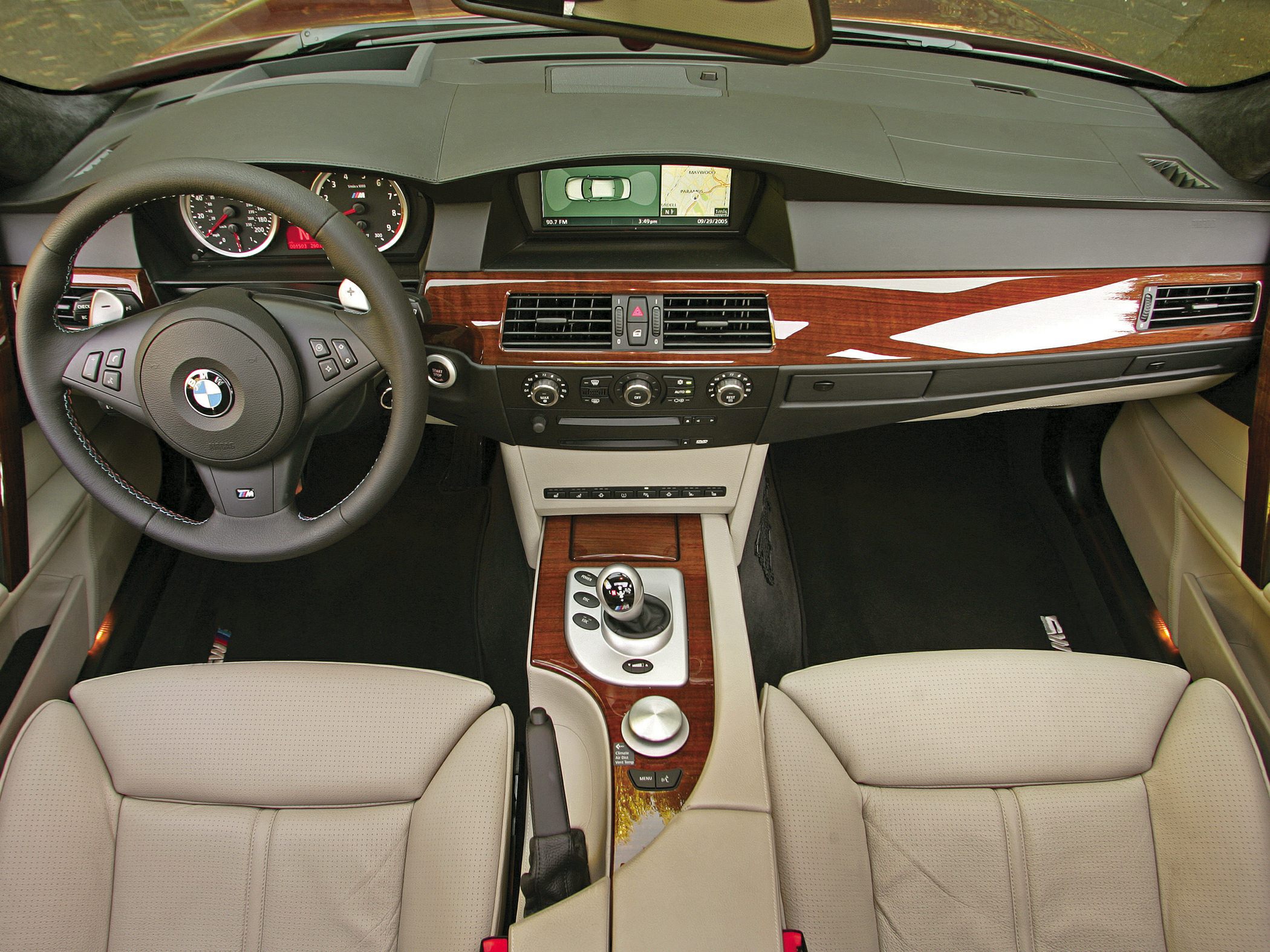 Luxury car interior with wood trim and manual gear shifter