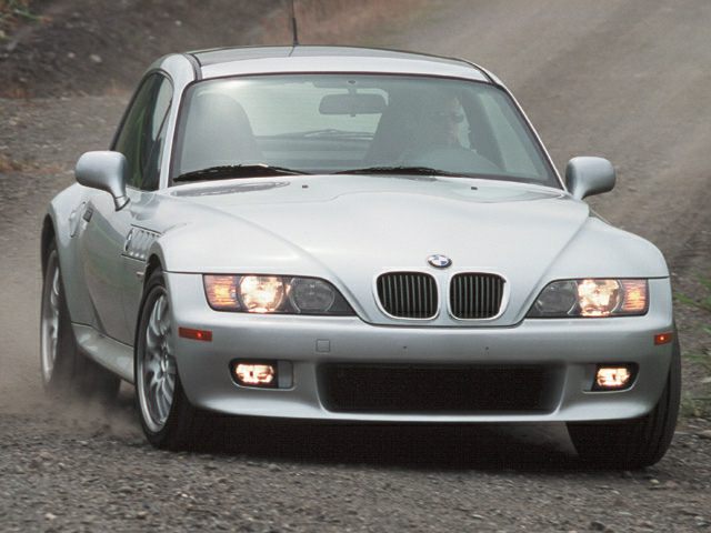 Front view with headlights and fog lights on, distinctive kidney grilles visible