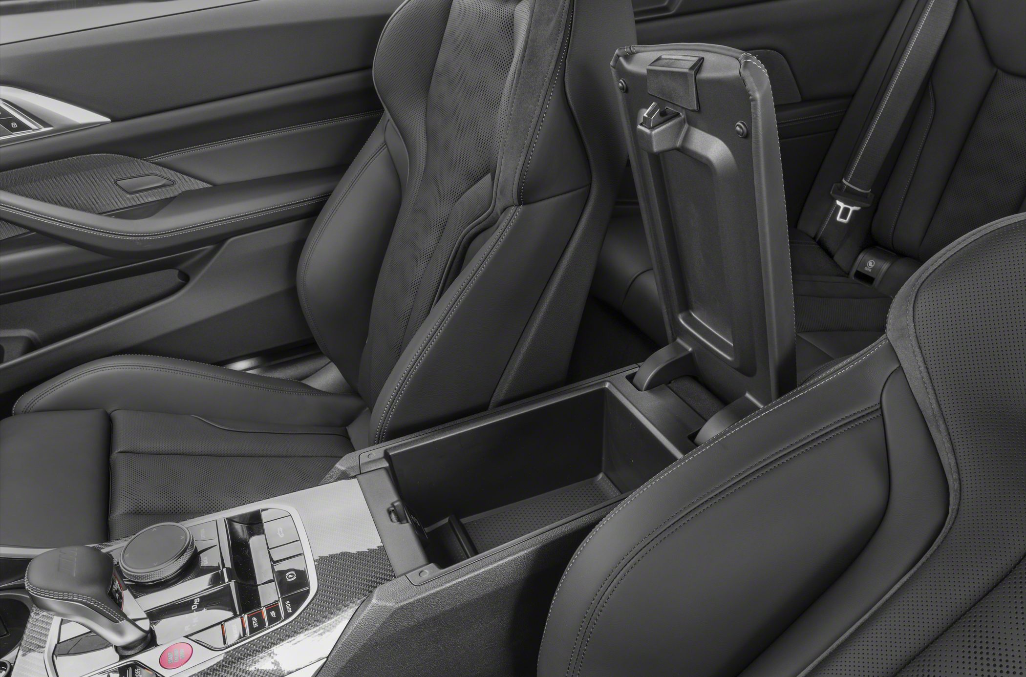 Open center console storage and sporty leather seats in a luxury car interior