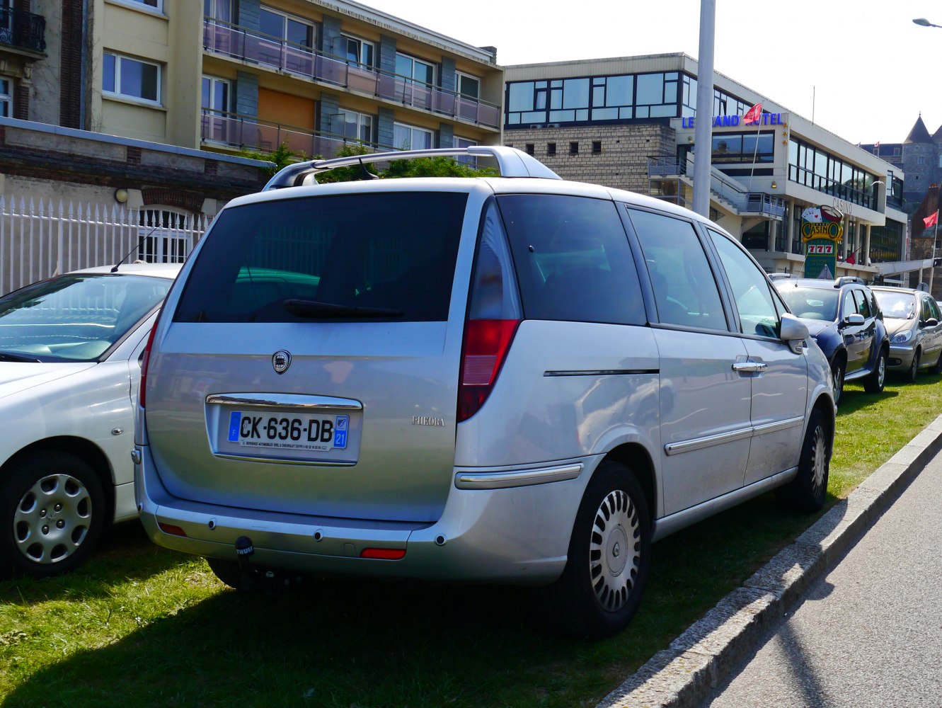 Silver MPV rear and side view with roof rails and tinted windows