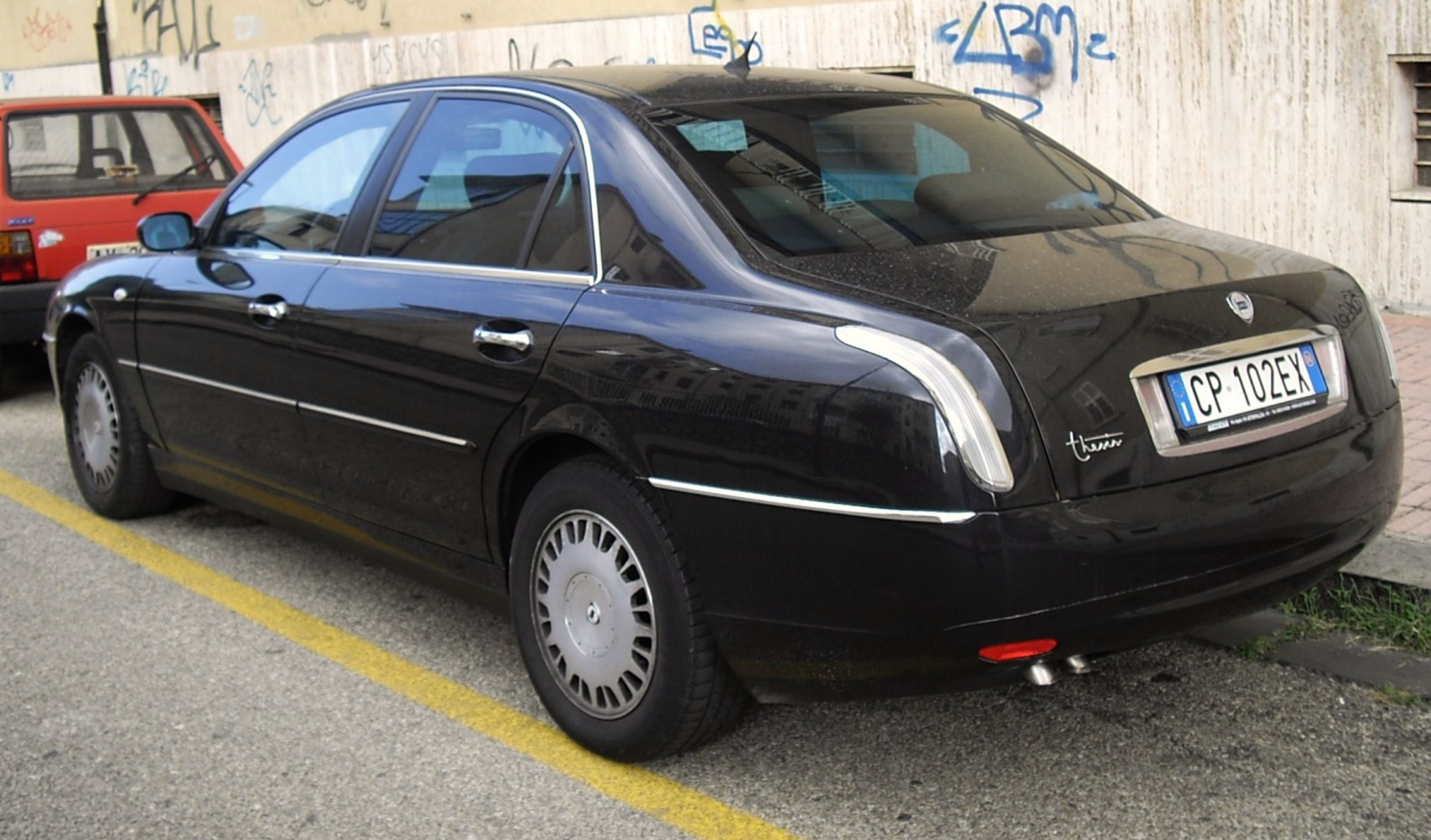 Luxury sedan rear with vertical taillights and chrome trim