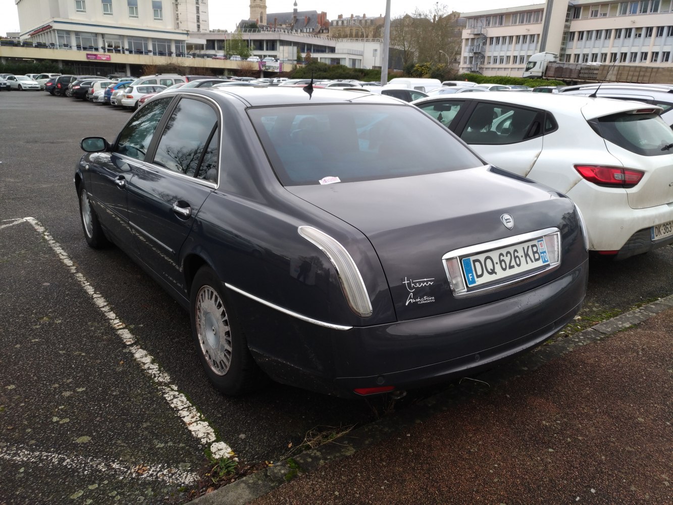 Rear view of sedan with vertical tail lights and chrome trim