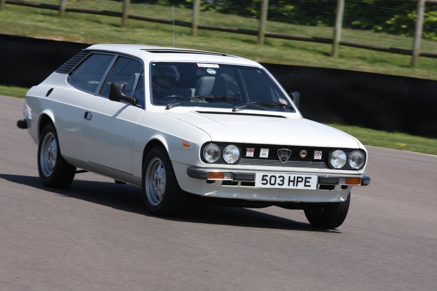 Front angled view showing quad round headlights and sleek coupe shape