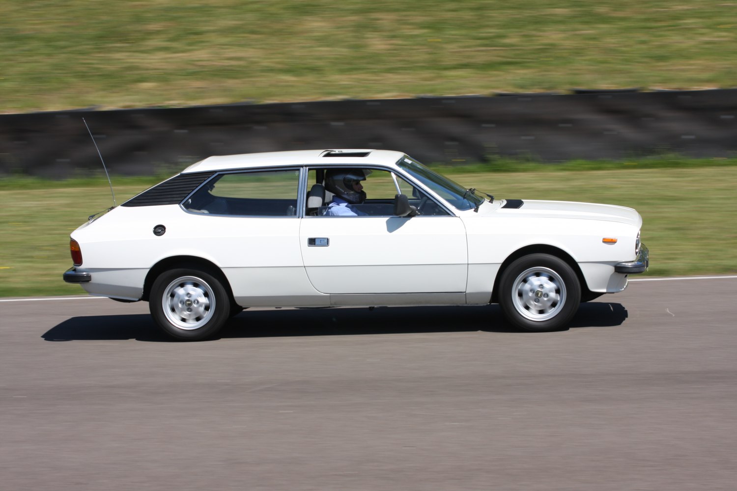 Side profile of white vintage coupe with sunroof