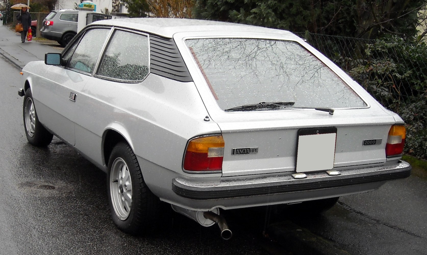 Rear hatchback design with rear window wiper and distinctive taillights.