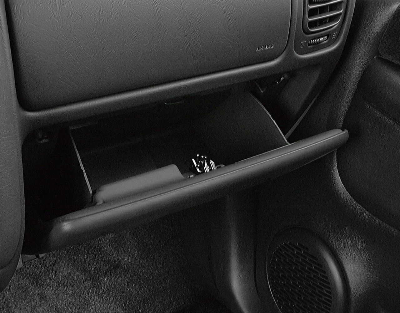Open glove compartment with visible interior storage space