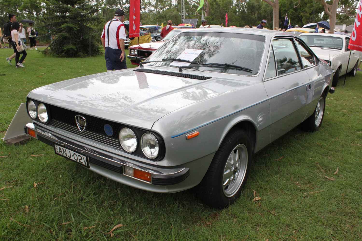Silver coupe with dual round headlights and chrome bumpers