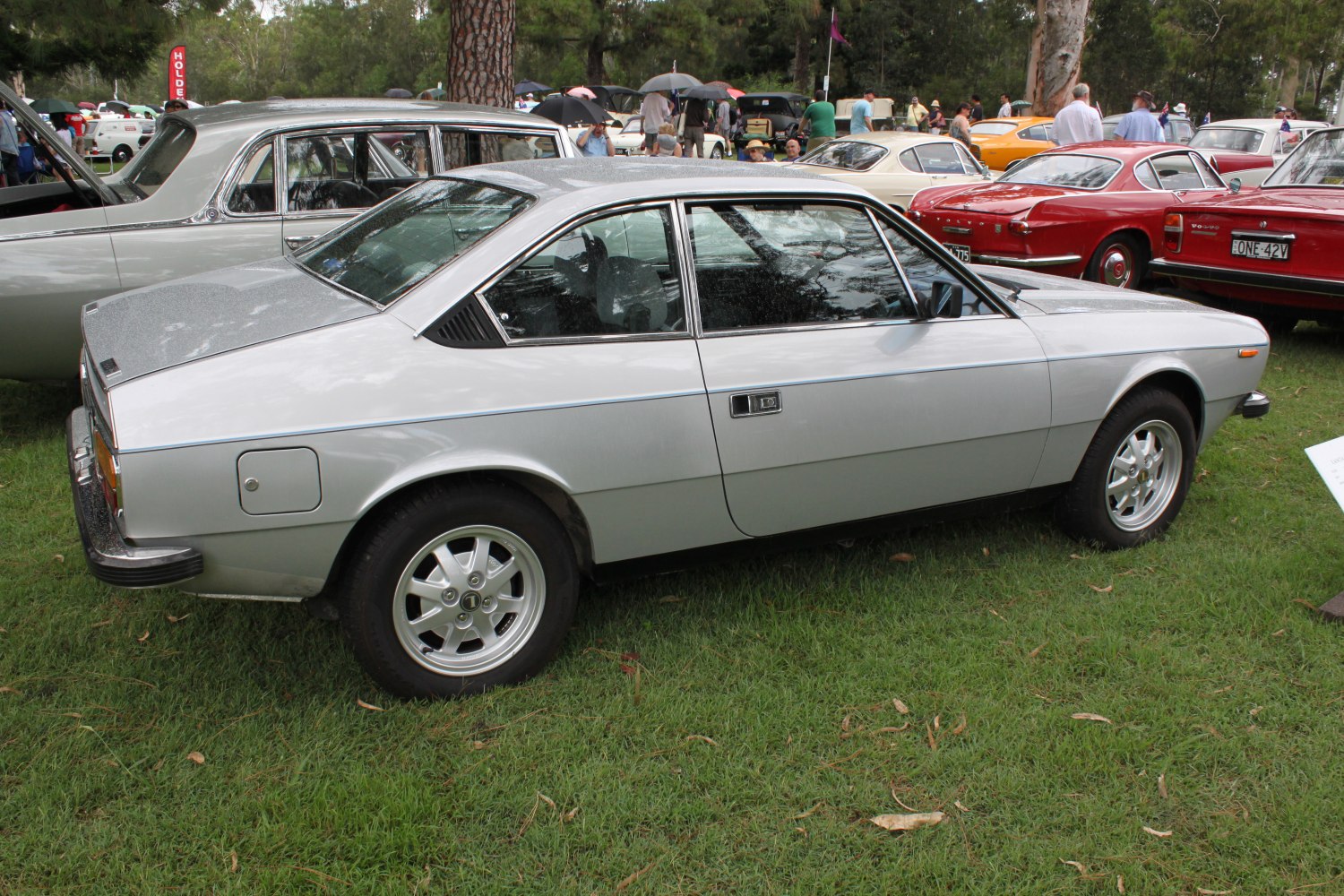 Silver vintage coupe with distinctive angular side profile and alloy wheels