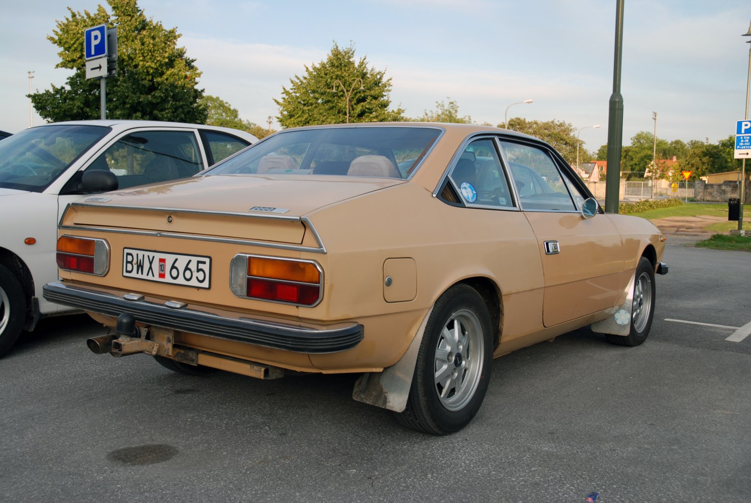 Rear view of vintage coupe with angular tail lights and bumper
