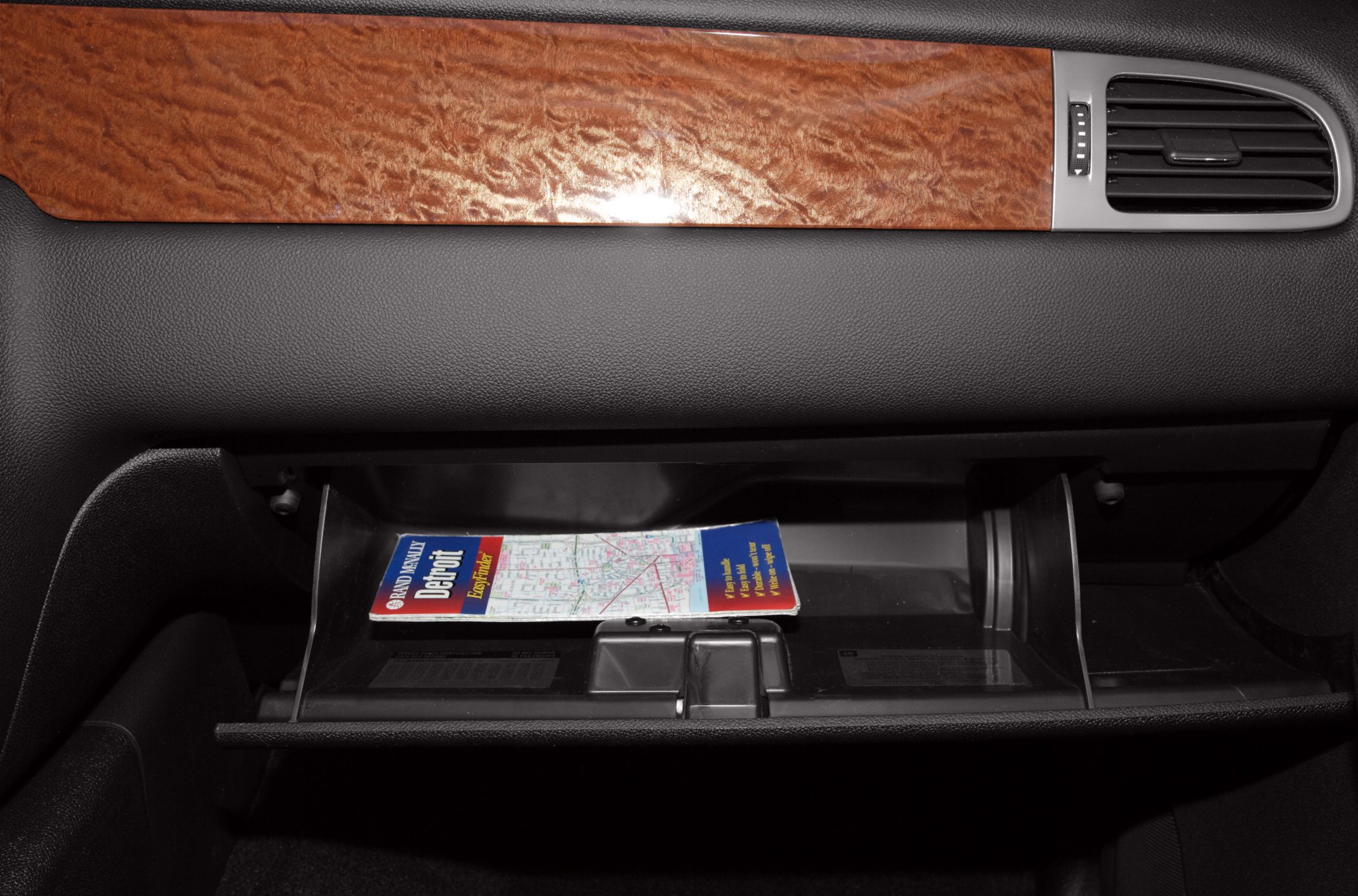 Glovebox interior with wood trim and air vent