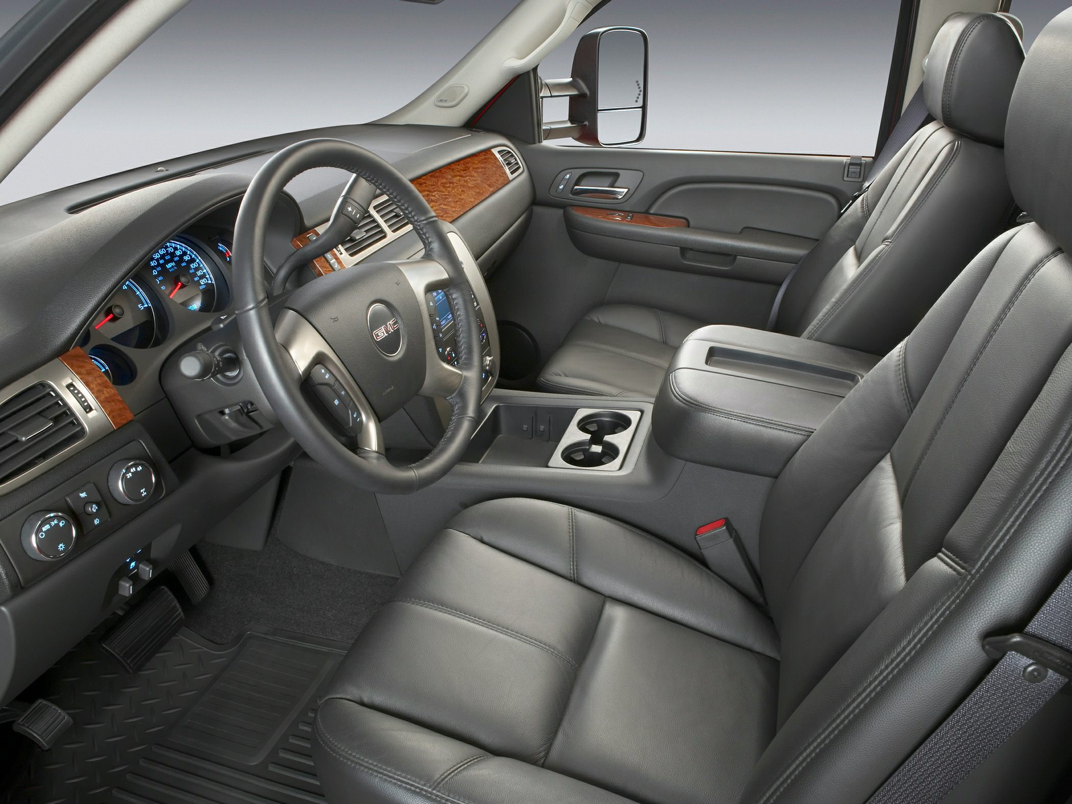 Leather seats and wood-trimmed dashboard with steering wheel and center console