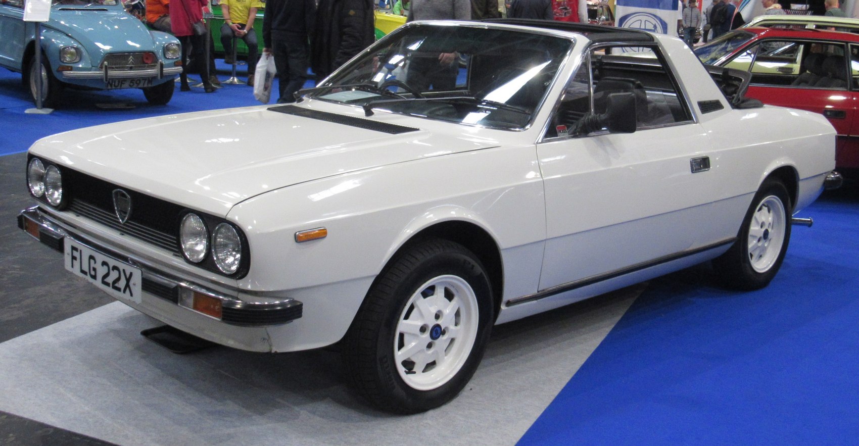 White Lancia Beta Spider Targa coupe with round headlights and sporty white wheels