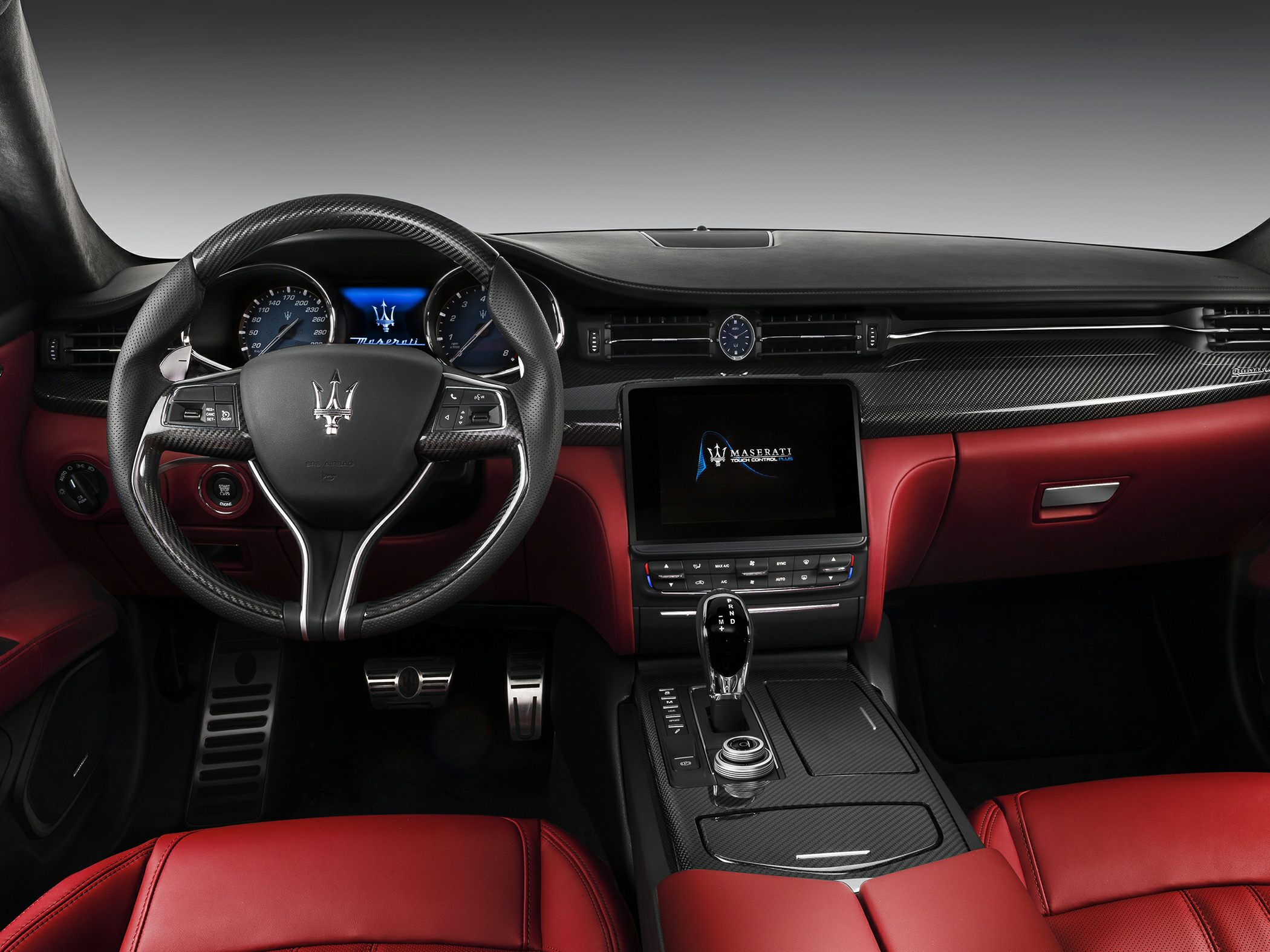 Carbon fiber dashboard and red leather interior with advanced infotainment