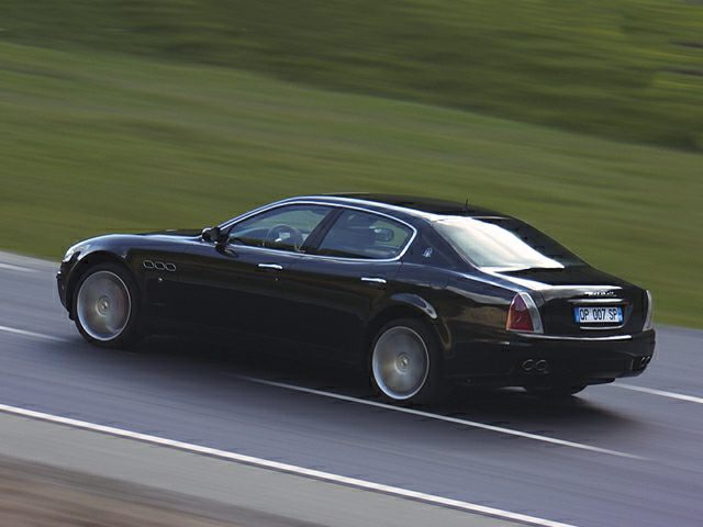 Rear three-quarter view of a luxury sedan in black
