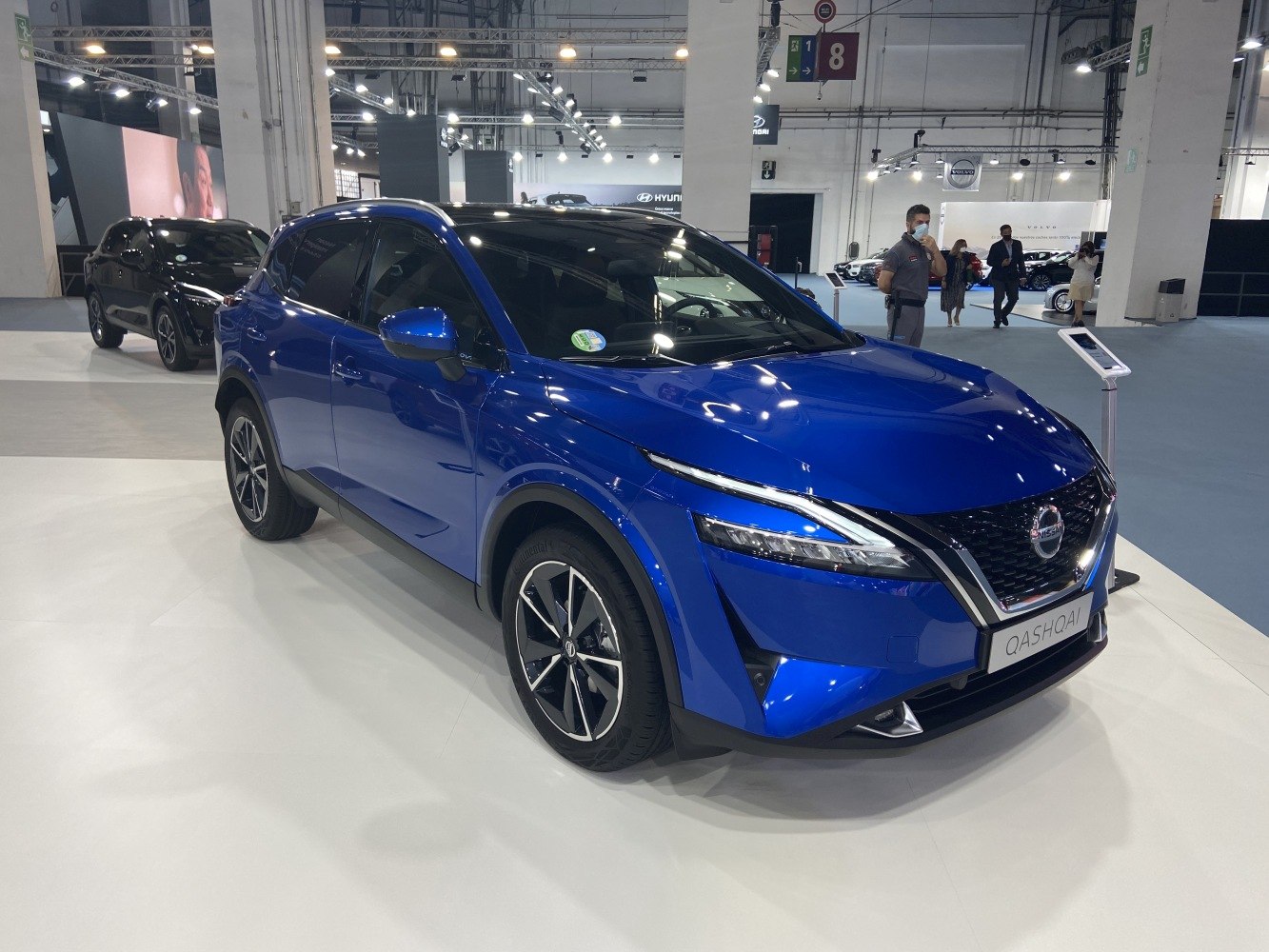 Front and side view of blue sleek SUV with modern headlights