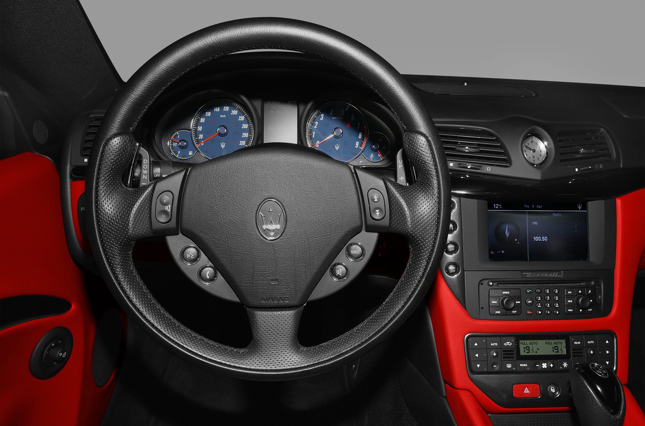 Steering wheel with blue dials and sporty dashboard layout
