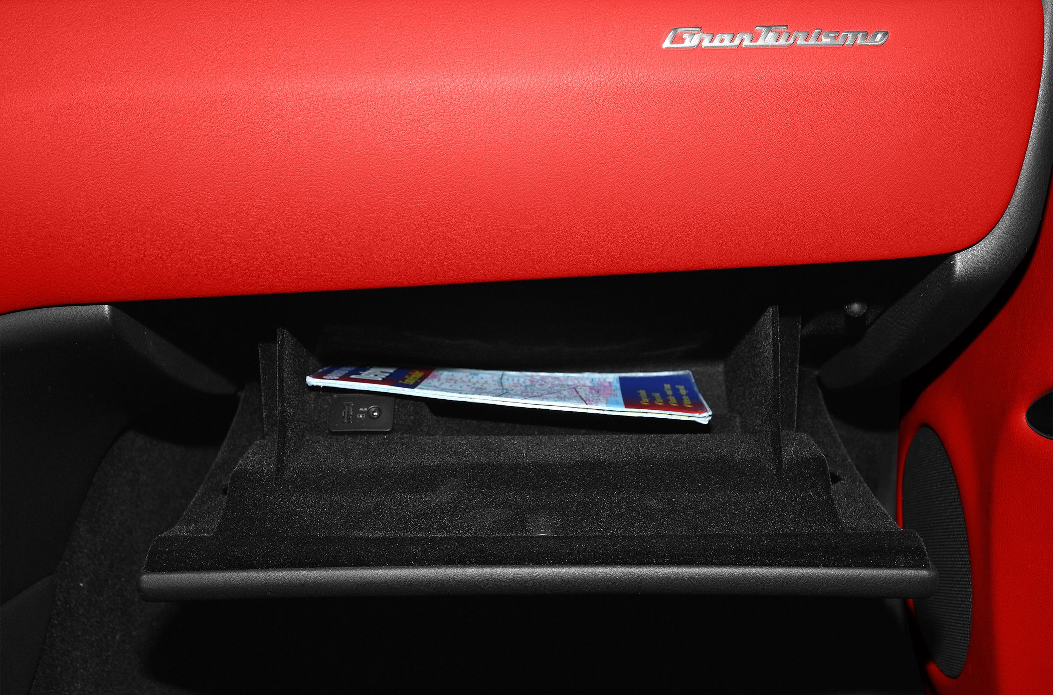 Glove box with red leather dashboard and interior storage space