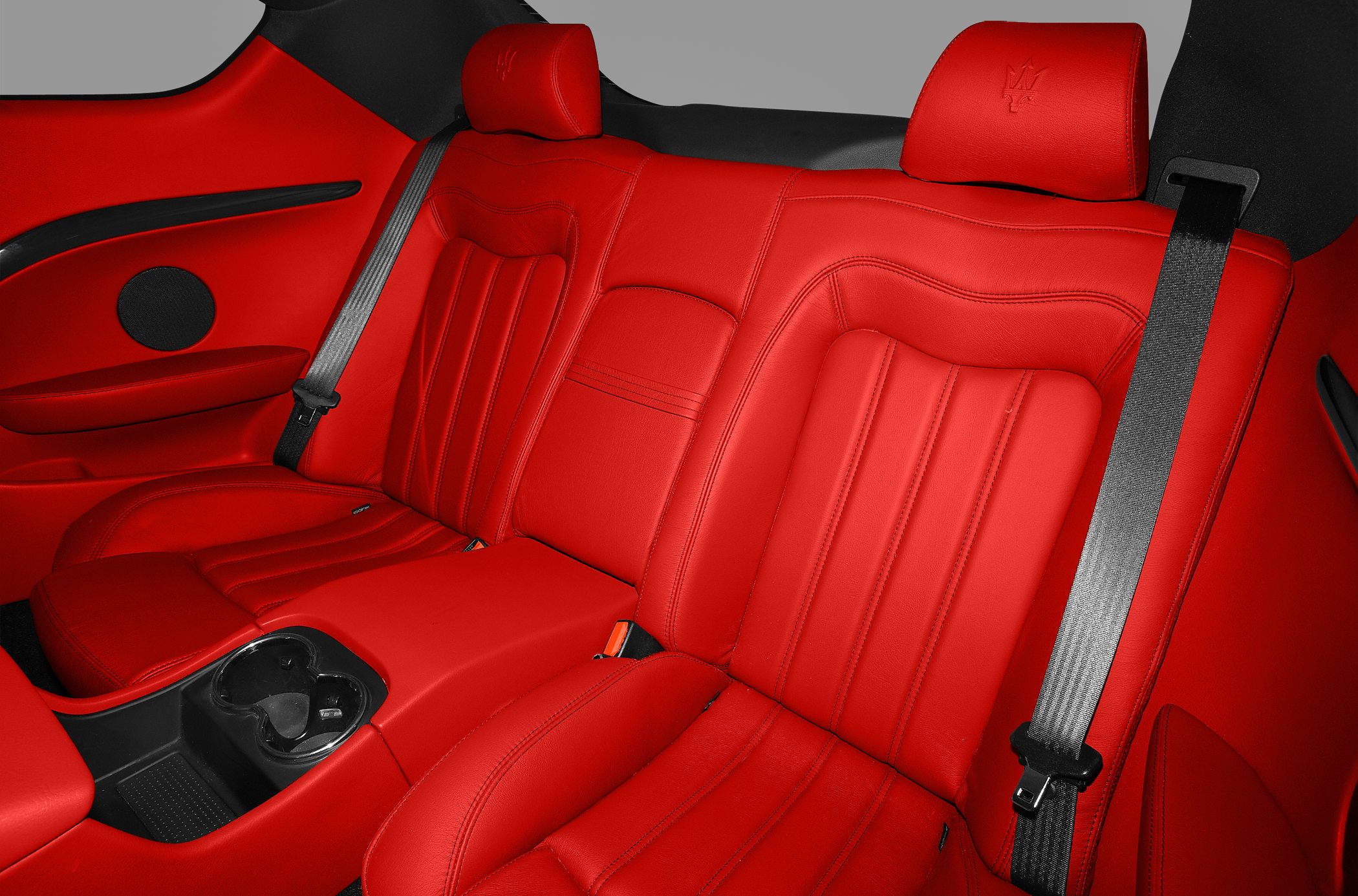 Red leather rear seats with black seat belts and headrests