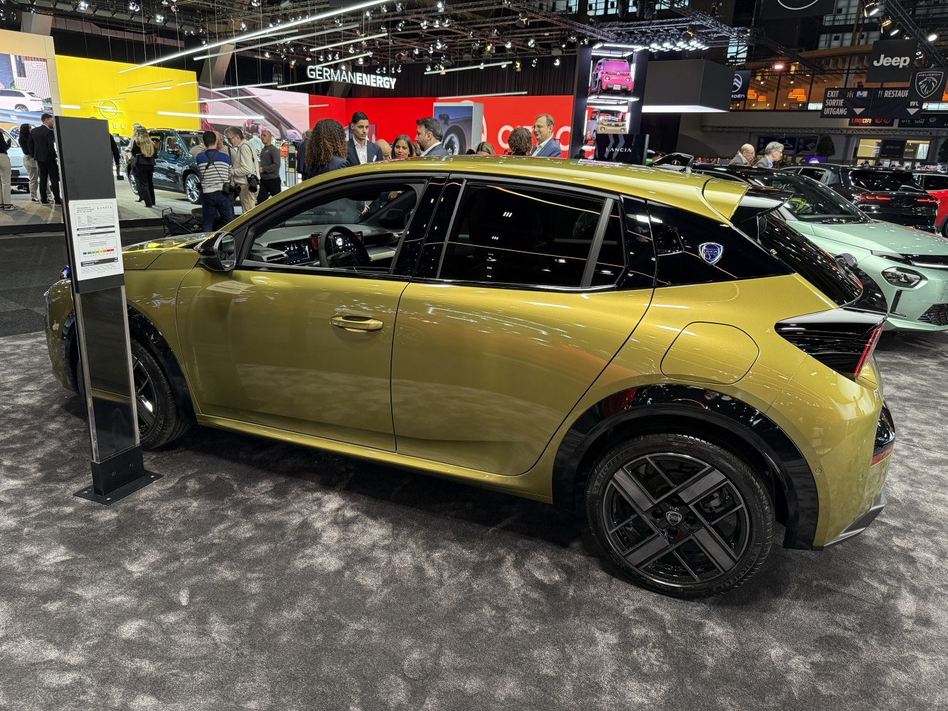 Side profile of a sleek modern hatchback with two-tone trim and distinctive rear window design.