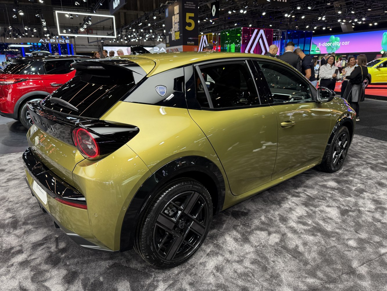 Rear and side view showing sleek hatchback design with black accents and alloy wheels