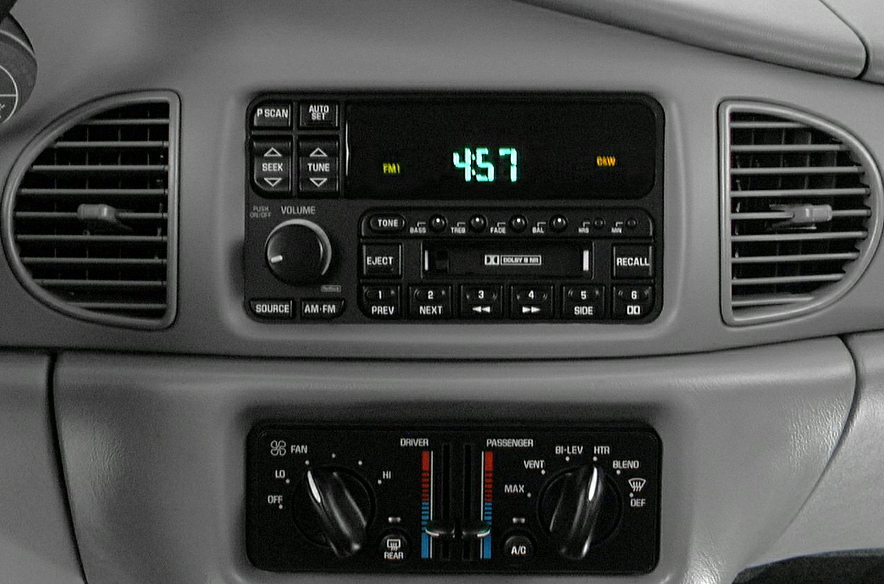 Classic car radio with digital clock and dual-zone climate control knobs